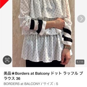 Border at Balcony of Japan flowy tiered White polka dot Blouse with navy blue